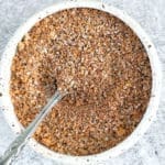 Texas roadhouse steak seasoning in a small bowl with spoon.