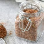 Steak rub in a small glass jar and on a small spoon.