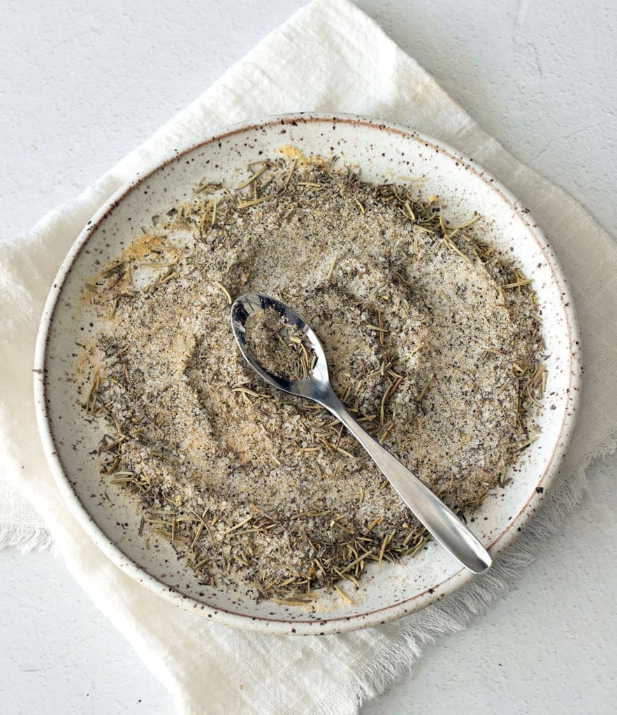 Plate of spices with a spoon.