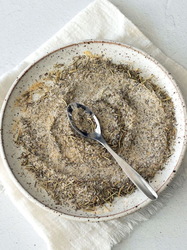 Plate of spices with a spoon.