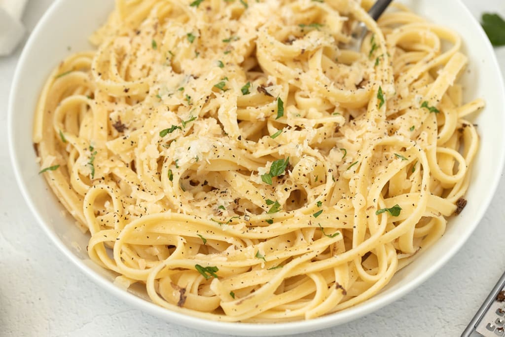 white bowl with pasta inside.