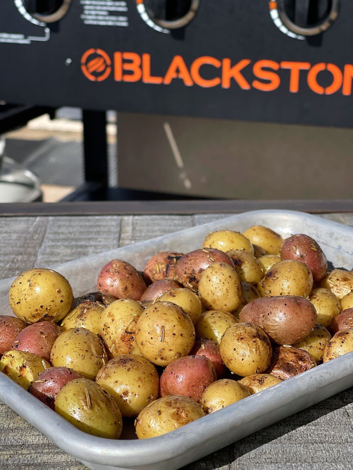 Blackstone potatoes on a silver baking sheet.