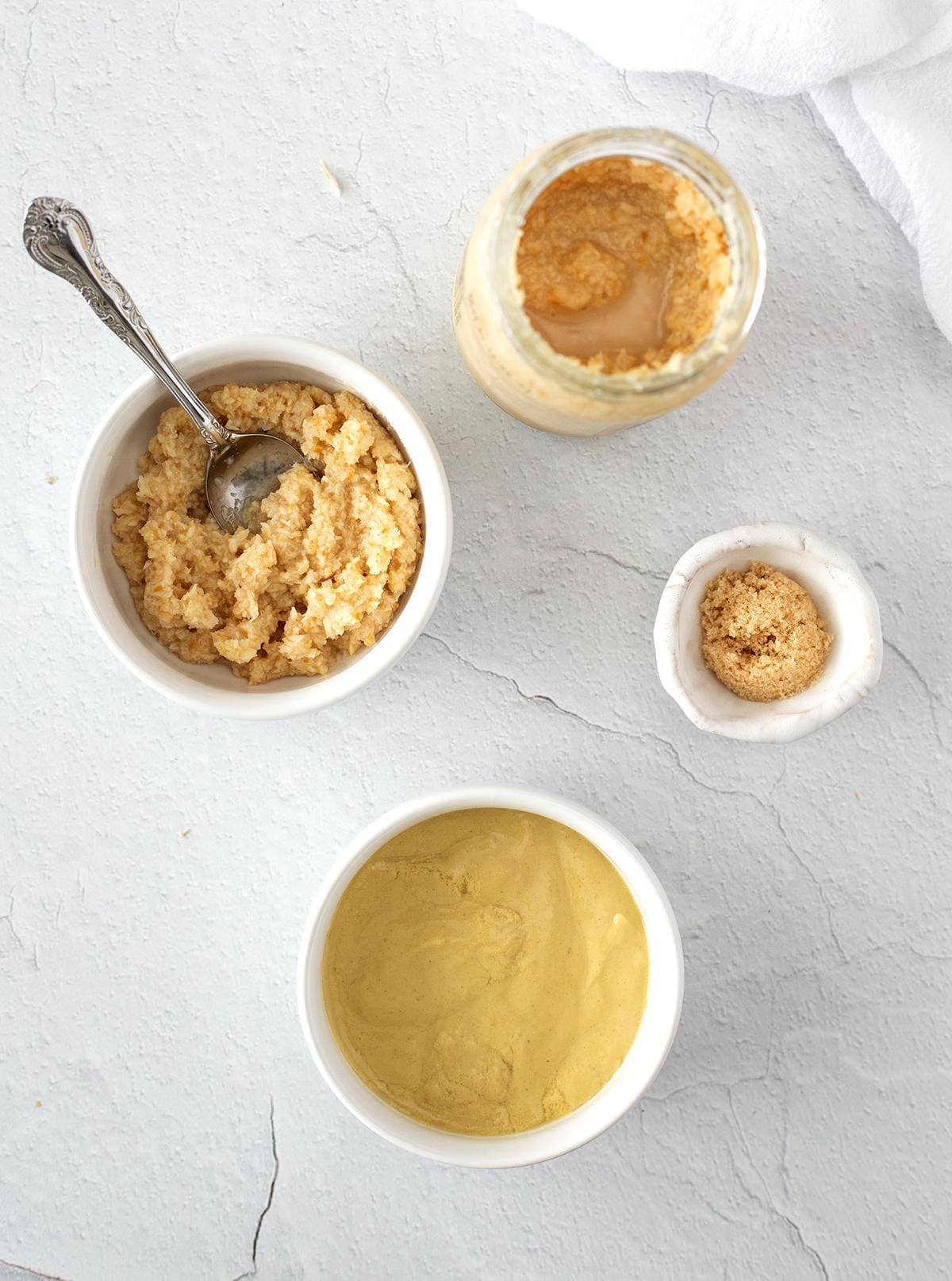 Ingredients to make horseradish mustard sauce in small bowls.
