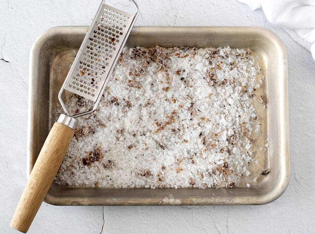 Truffled Salt on a baking sheet with a microplane.