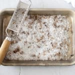 Truffled Salt on a baking sheet with a microplane.