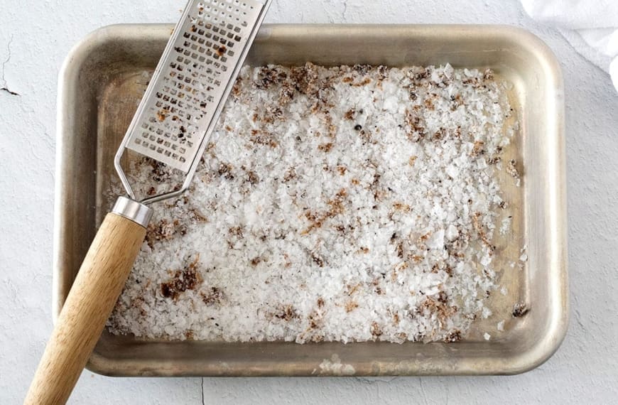 Truffled Salt on a baking sheet with a microplane.