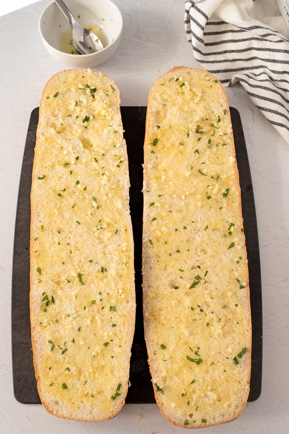 French bread sliced in half covered in garlic butter.