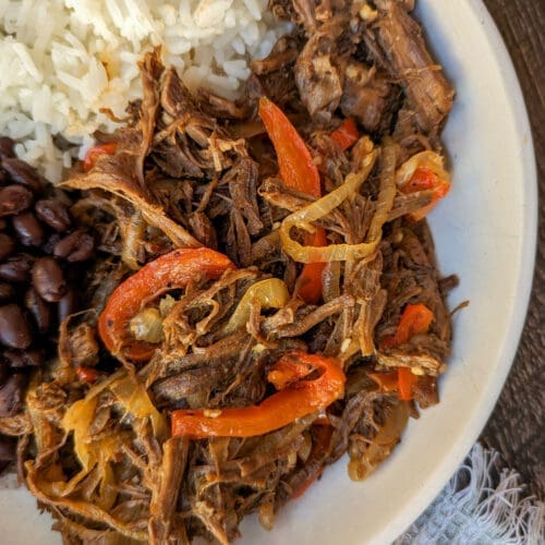 30+ Beef Chuck Roast Recipes 26 Carne Mechada on a plate with rice.