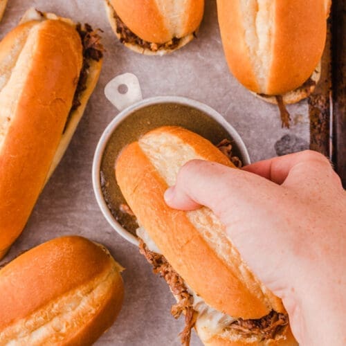 30+ Beef Chuck Roast Recipes 30 Hand dipping a French Dip Sandwich in au jus.
