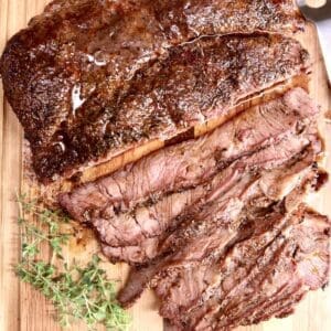 30+ Beef Chuck Roast Recipes 4 Grilled chuck roast sliced on a cutting board.