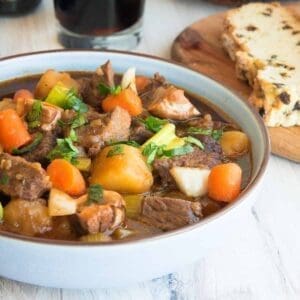 30+ Beef Chuck Roast Recipes 23 Guinness beef stew in a white dutch oven.