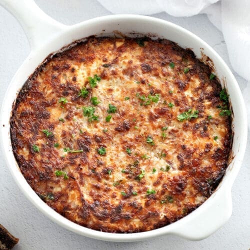 Hot reuben dip in a white round baking dish.