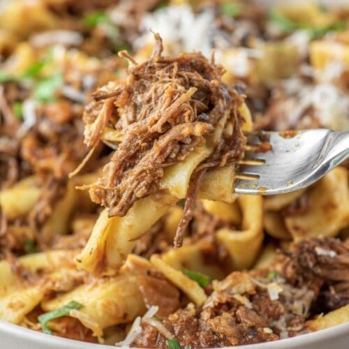 30+ Beef Chuck Roast Recipes 19 Bowl of beef ragu being held with a fork.
