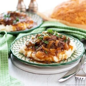 30+ Beef Chuck Roast Recipes 27 French onion pot roast on a green and white designer plate.