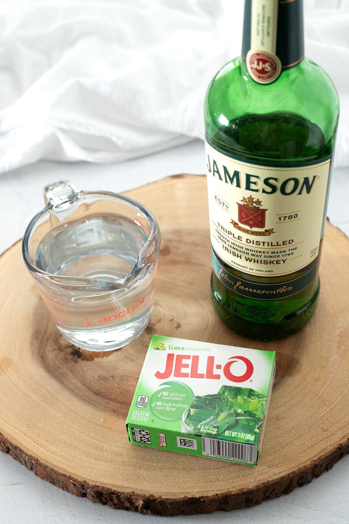bottle of Jameson whiskey, box of jello and cup of water. 