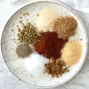 8 spices on a plate to make carnitas seasoning.