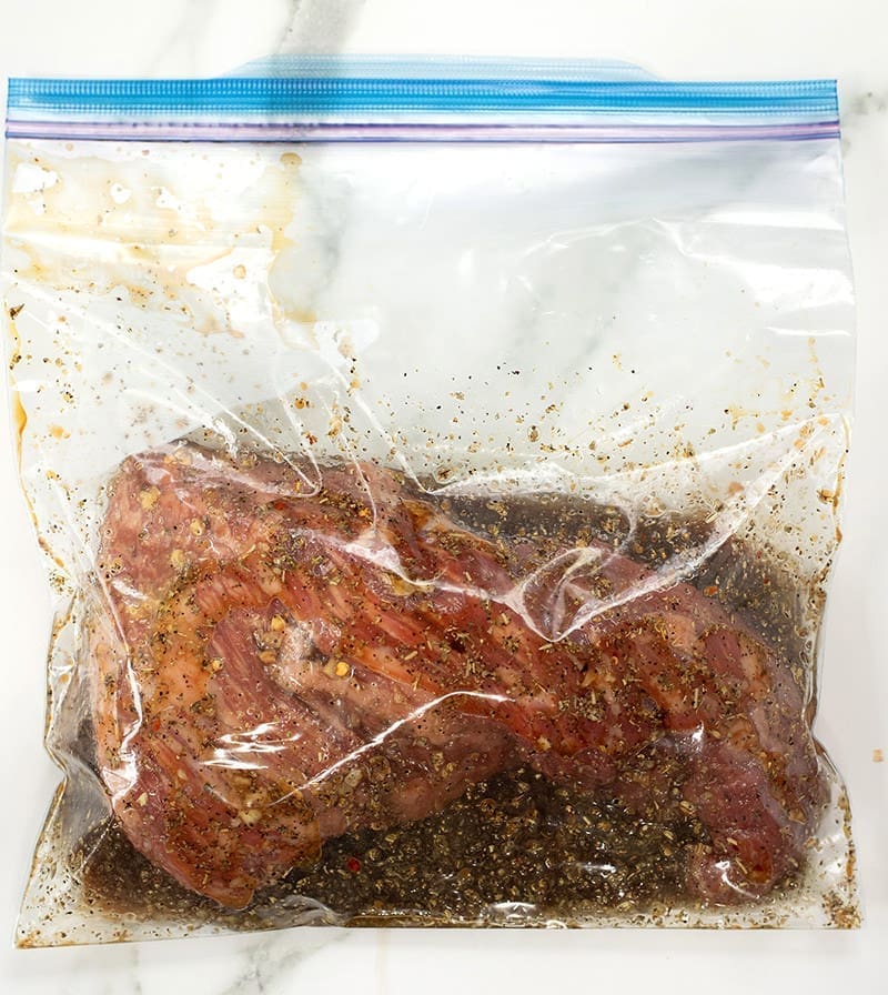 Beef roast in a Ziploc Bag filled with liquid marinade.