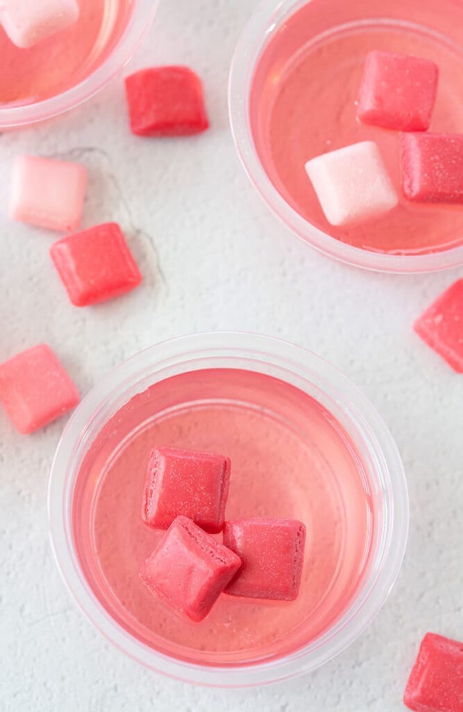 plastic gelatin cups with candy on top.