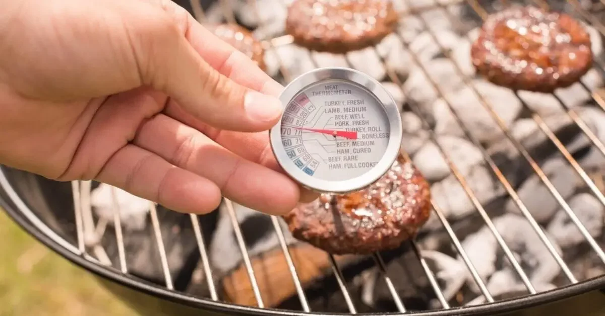 hamburger temperature measuring patties on a grill