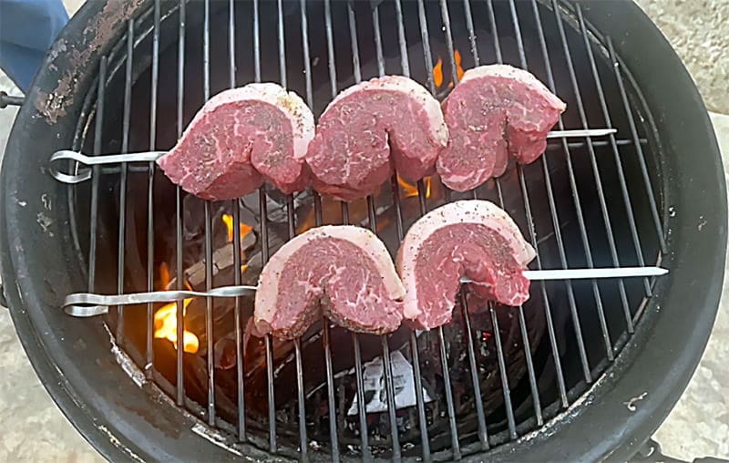 Picanha steak on a wood grill.