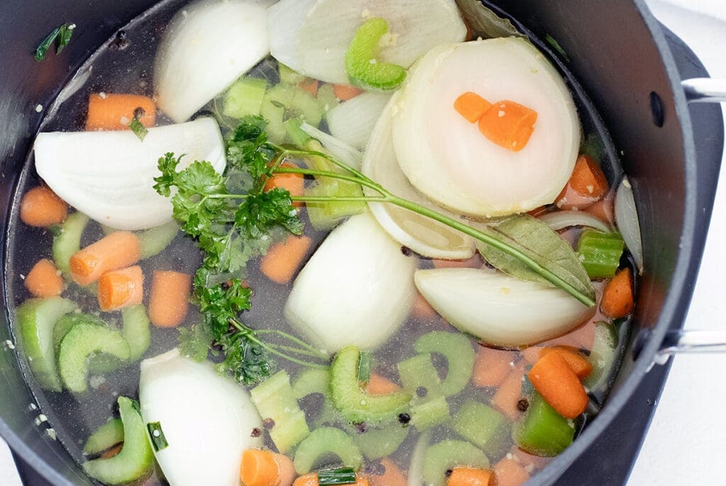 Water and raw vegetables in a stockpot.