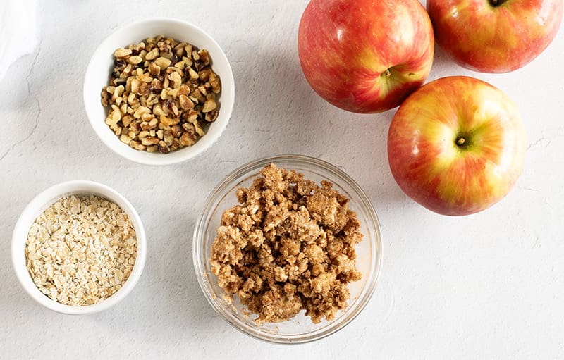 Small bowls filled with oats, nuts and other fall dessert ingredients.