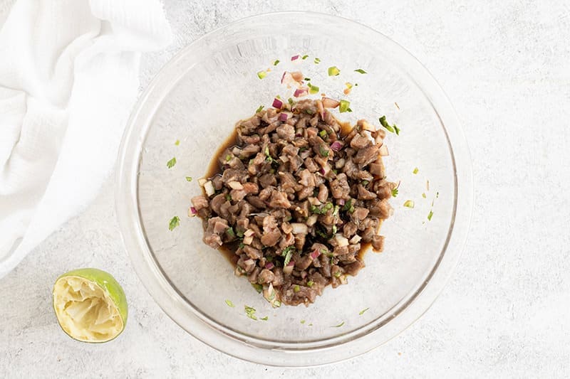 Tartare with filet mignon in a glass bowl.