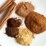 Mix of spices on a plate for Pumpkin Pie Spice Substitutes article.