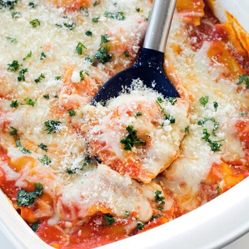 I baked ravioli served with black and silver spoons.
