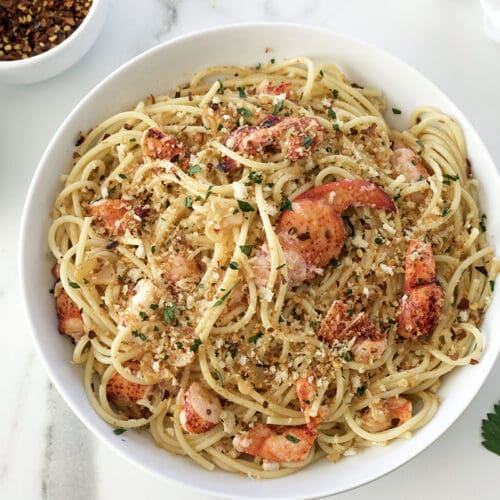 White bowl of lobster pasta.