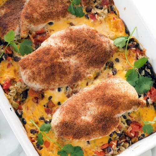 Queso chicken in a white baking dish.