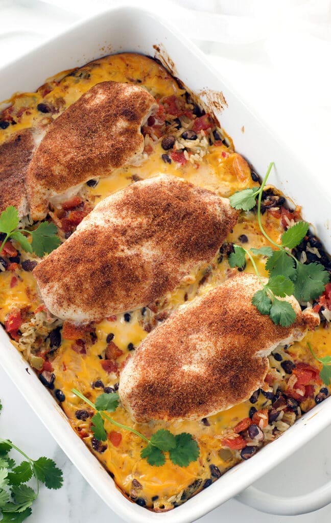 Queso chicken and rice in a white baking dish.