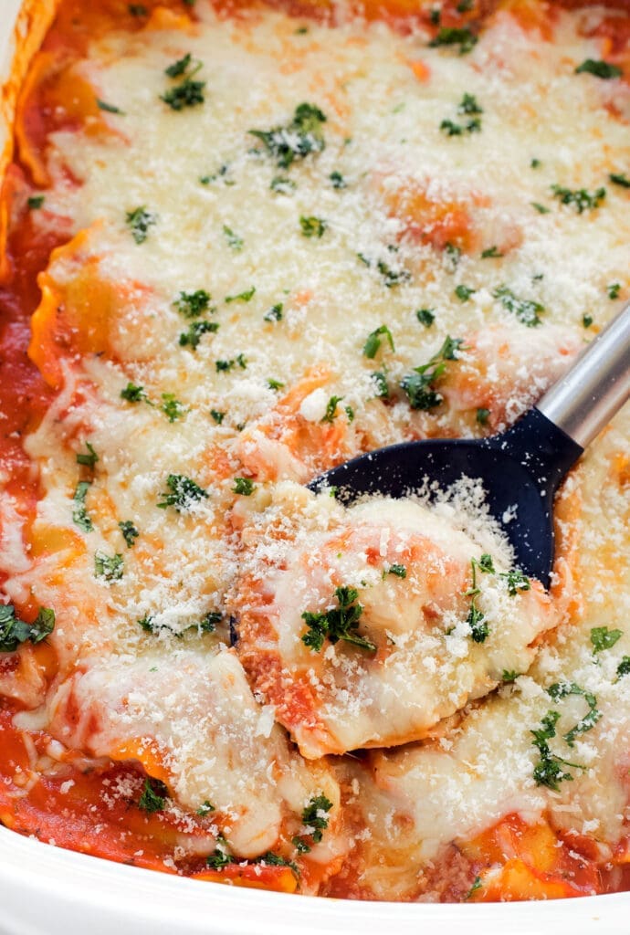A black spoon that serves ravioli bake.