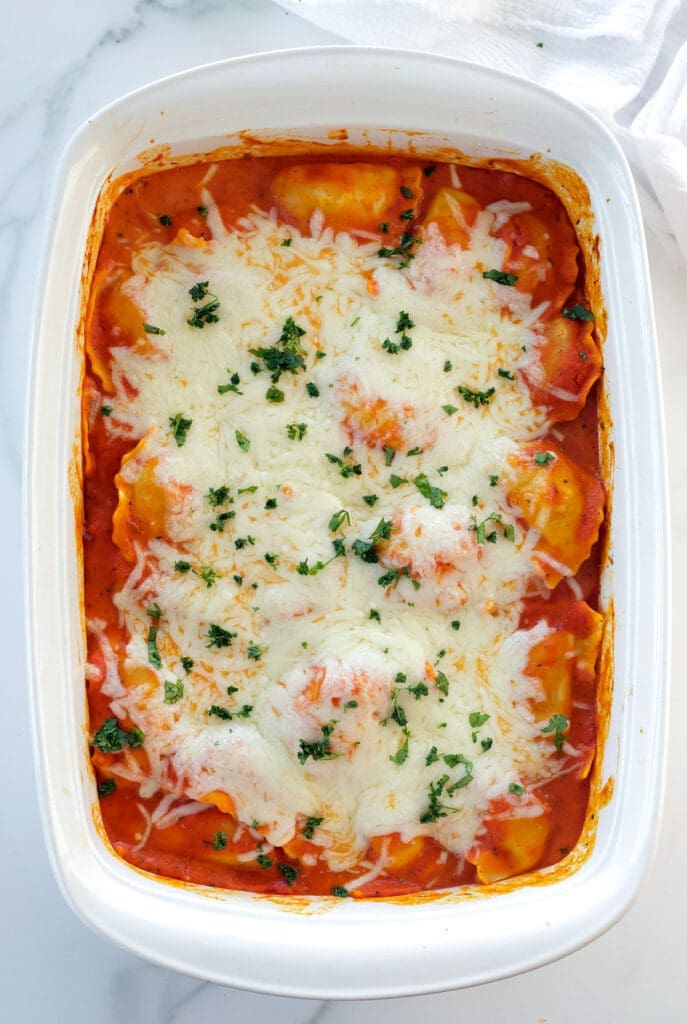 White dishes filled with pasta and cheese.