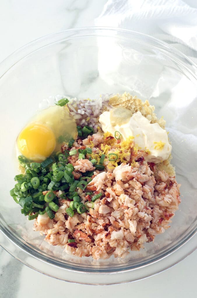 Ingredients for making lobster cake in a clear bowl