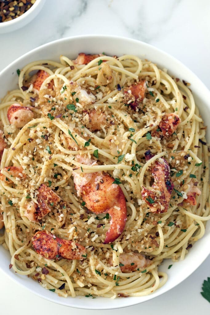 A bowl of pasta and lobster.