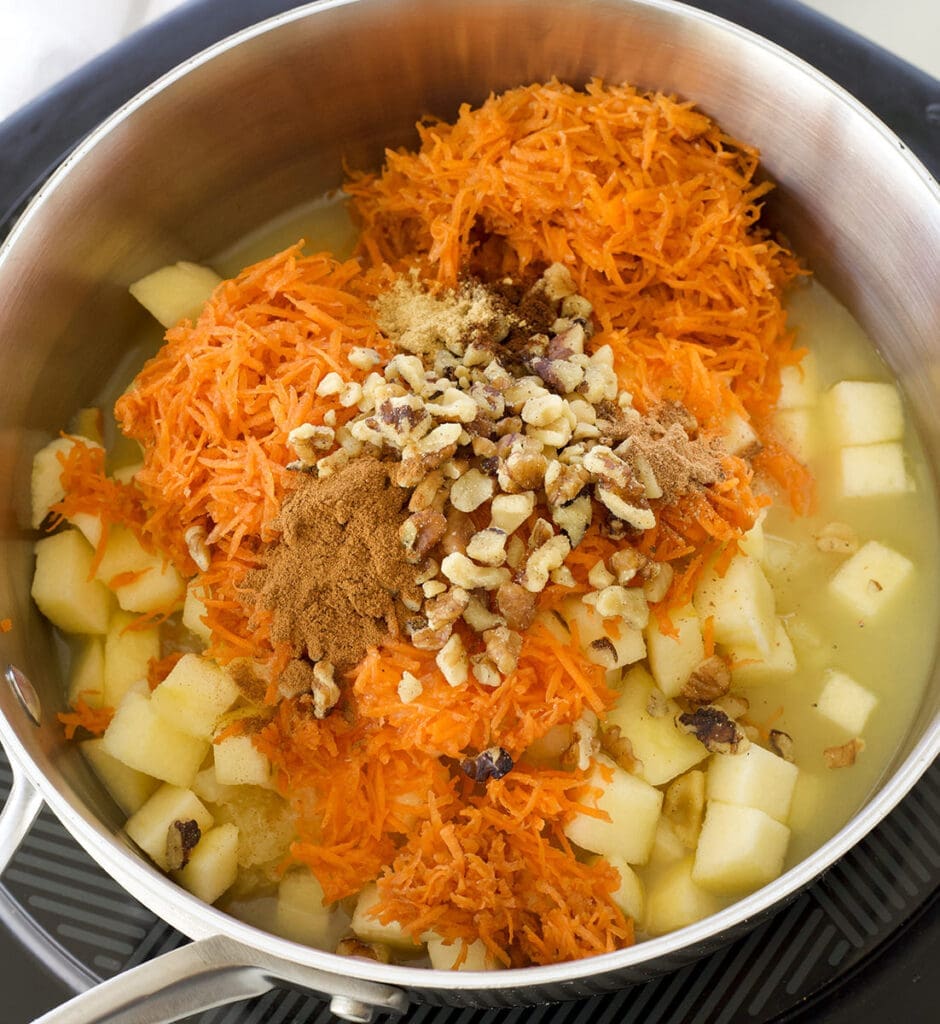 A pot full of fine carrots, nuts and spices.