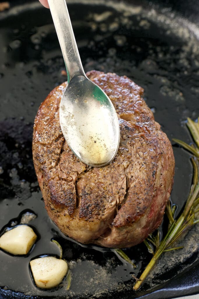 Brush steak with silver spoon butter.