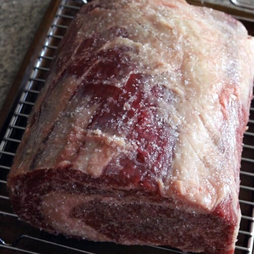 Close up prime rib on a baking sheet for how to dry brine prime rib article.