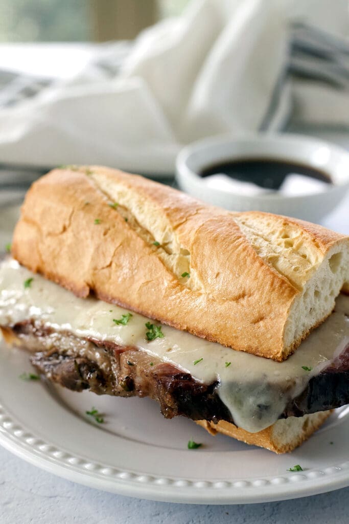 Prime Rib French Dip Sandwich on a white plate.