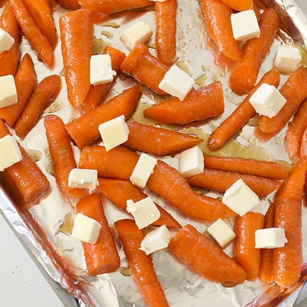 carrots and butter on a baking sheet.