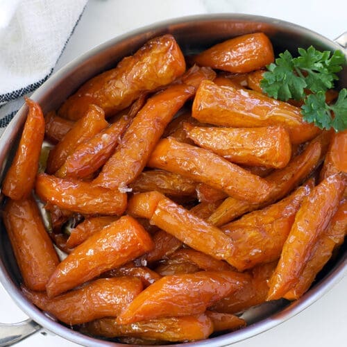 Silver baking dish of glazed carrots.