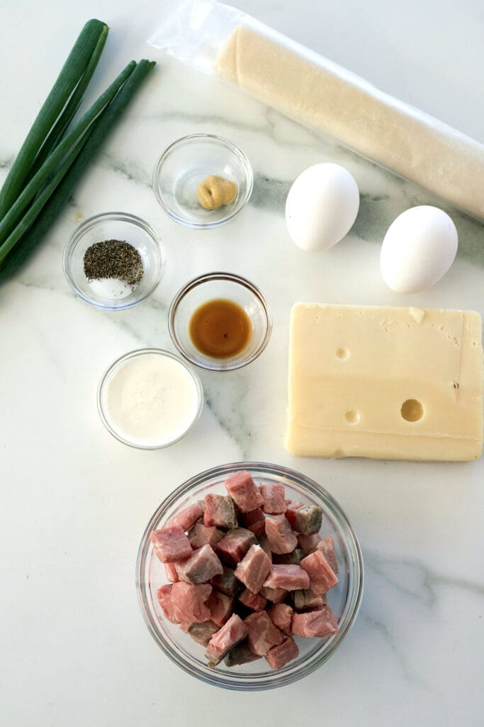 Labeled photo showing the ingredients to make egg quiche.