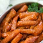 Maple Glazed Carrots in a silver baking pan.