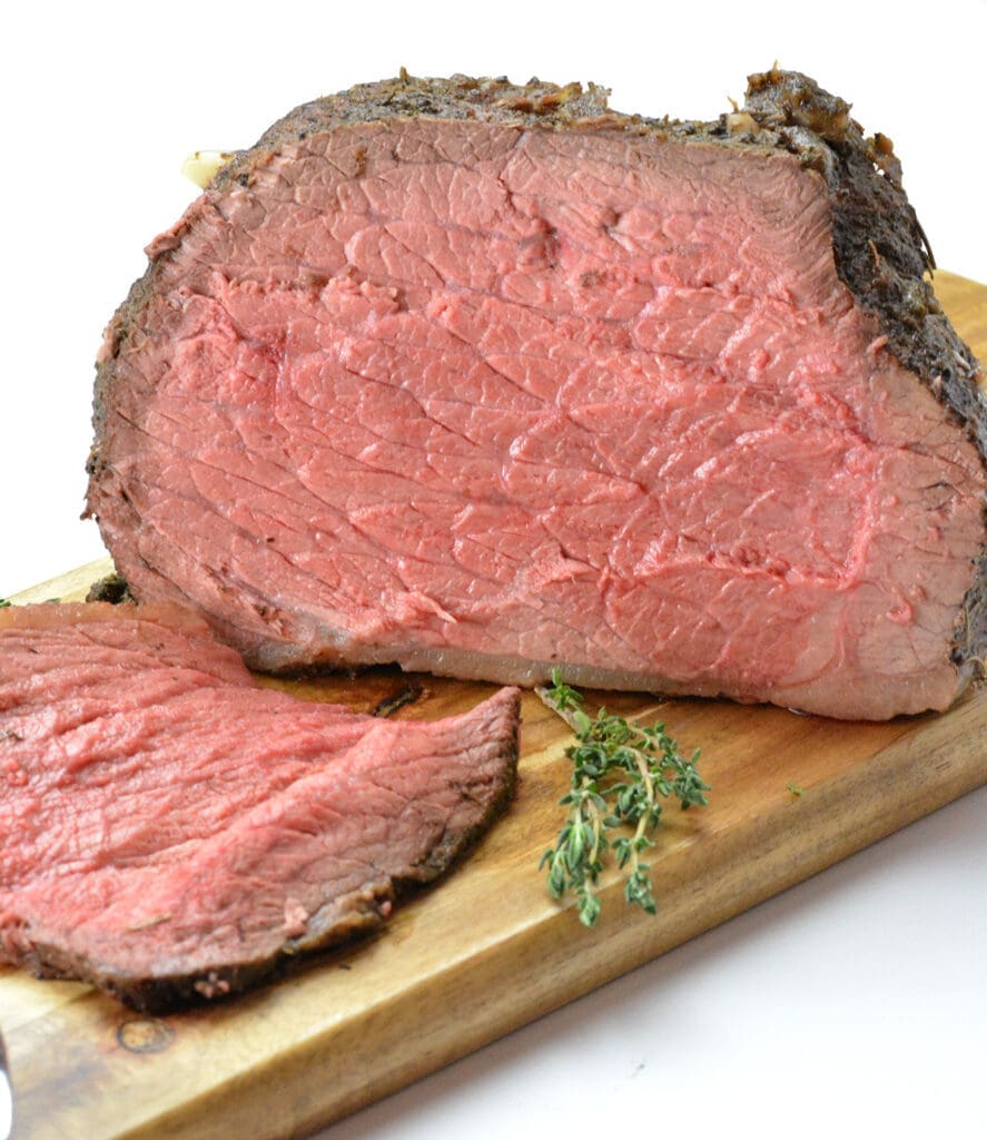 Cut roast beef on a cutting board.