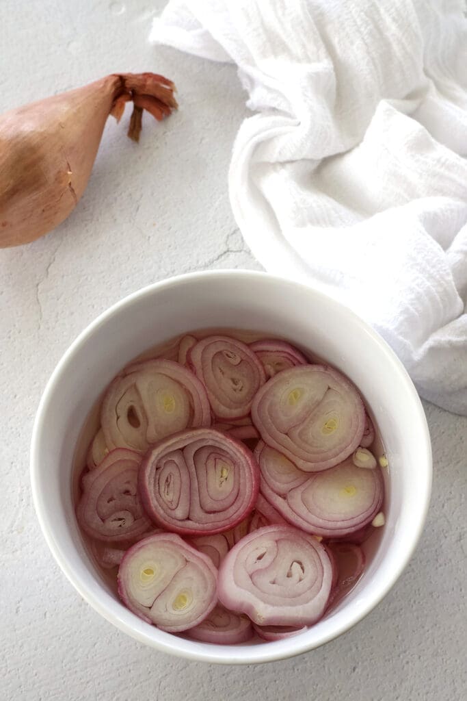 A white container containing pickled rakkyo.