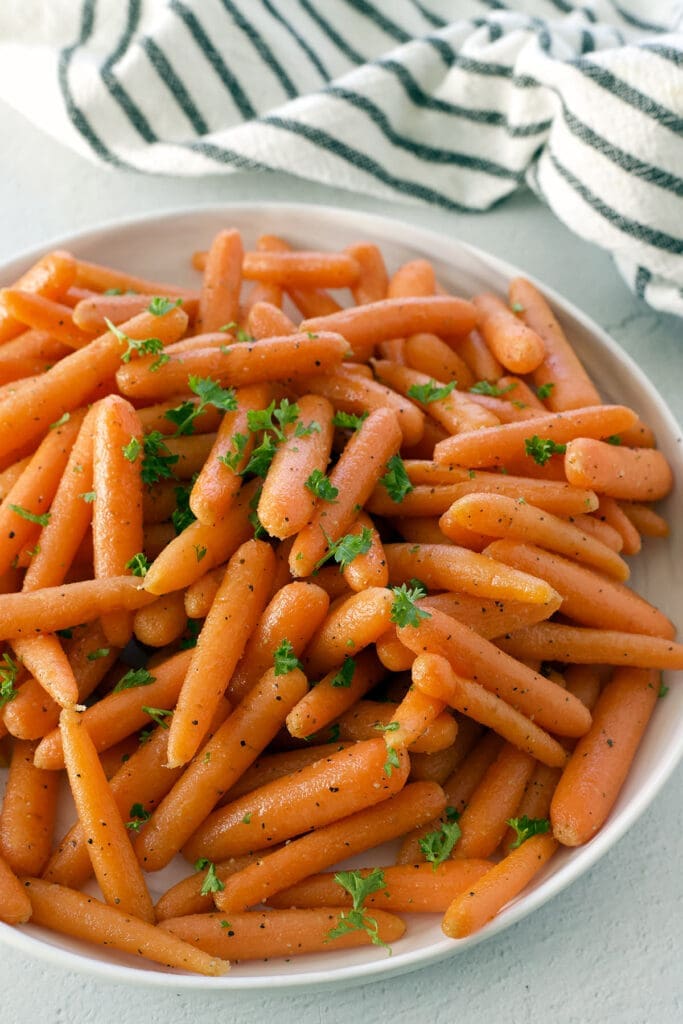 White bowl of roasted carrots.