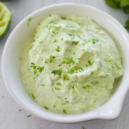 White ceramic bowl full of avocado crema.
