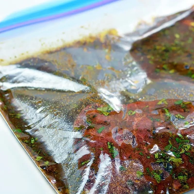 carne asada marinade and meat in ziploc bag.