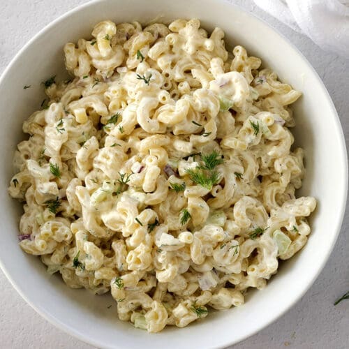 White bowl of classic macaroni salad.